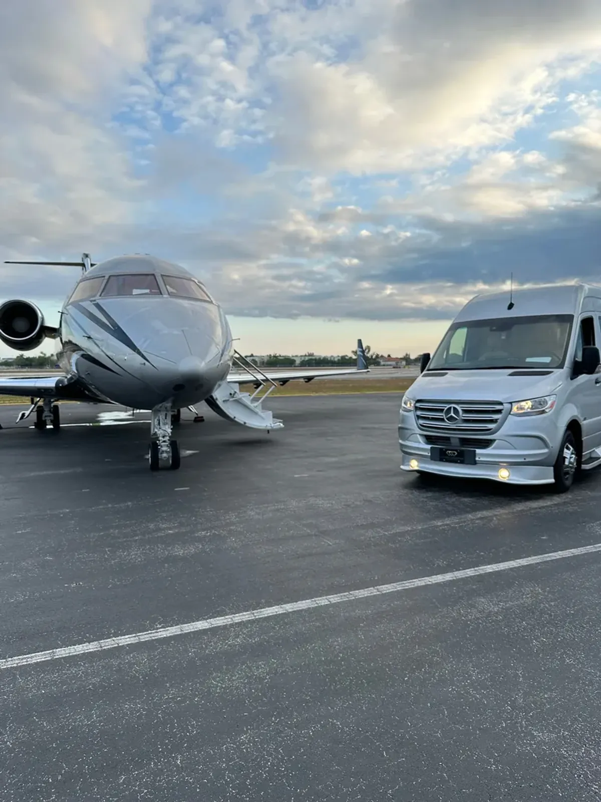 Decorated stretch limousine and two Mercedes Sprinter vans staged in front of The Biltmore Hotel in Coral Gables with the iconic tower visible behind them