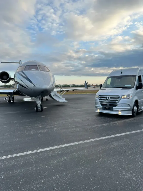 Corporate executive in black sedan during a multi-meeting day across Miami, professional and efficient