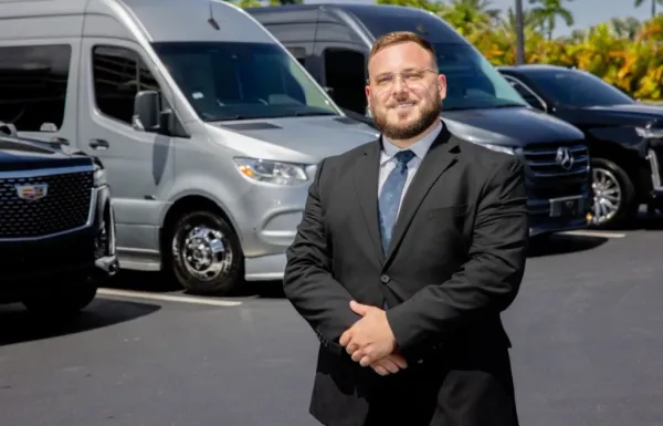 Executive reviewing a tablet in the back of a luxury SUV traveling on I-95 between Aventura and Downtown Miami