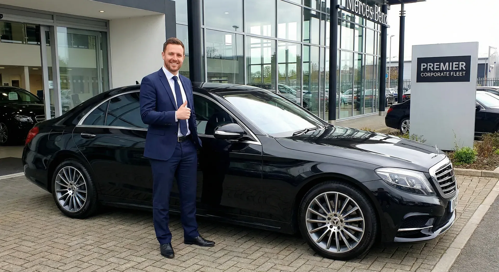 Professional executive stepping into a black luxury sedan outside a corporate office in Edgewater Miami with Biscayne Bay in background