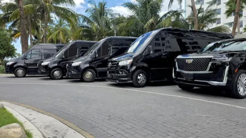 Chauffeur performing a final walkthrough inspection of a black Cadillac Escalade including checking tire pressure and adjusting interior settings