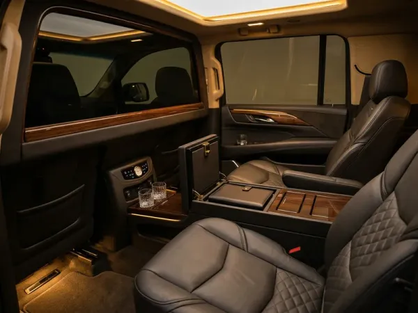 Black luxury sedan at Fort Lauderdale-Hollywood International Airport arrivals lane for a Sunny Isles Beach transfer