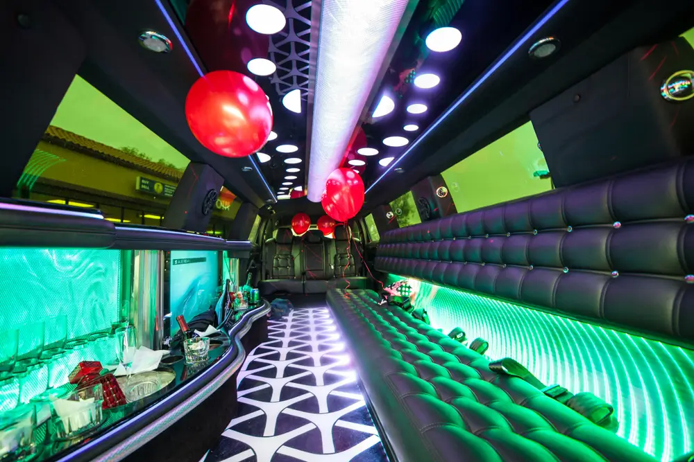 inside of a limousine with balloons and fancy interior lighting